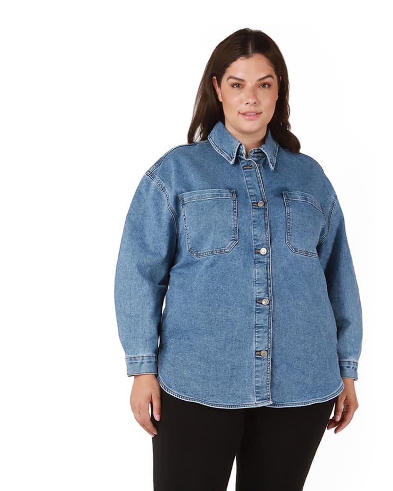 Front of a model wearing a size 0X Salma Rounded Hem Denim Shacket in Medium Wash by DEX PLUS. | dia_product_style_image_id:233719